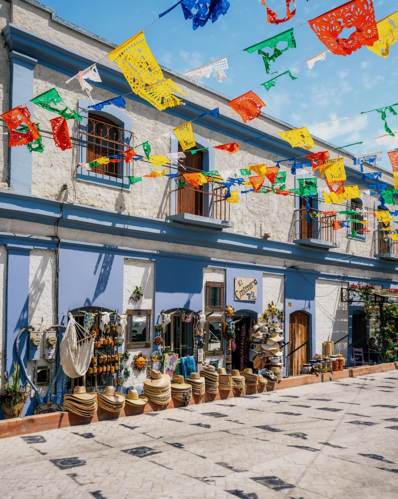 Papel picado and a blue façade in the historic centre, Todos Santos